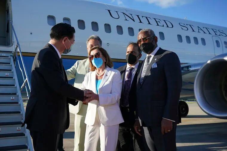 In this photo released by Taiwan's Ministry of Foreign Affairs, Taiwan's Foreign Minister Joseph Wu (left) speaks with U.S. House Speaker Nancy Pelosi as she prepares to leave in Taipei, Taiwan, on Wednesday.