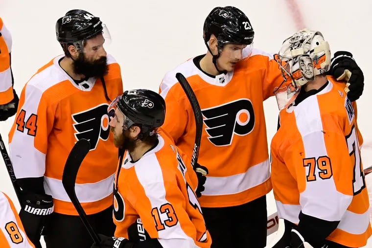 Oskar Lindblom (second from right) gives a hug to Carter Hart before the Flyers congratulate the Islanders for winning the series. The Flyers were 0-for-13 on the power play during the seven games against New York.