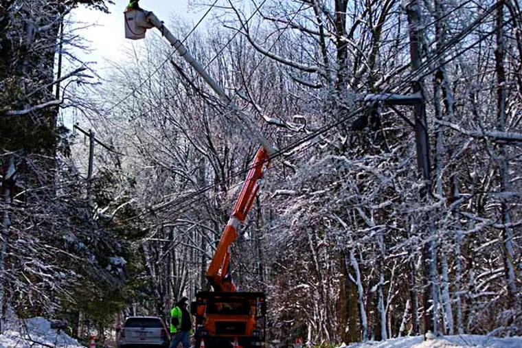Linesmen work to restore electrical power, Friday, Feb. 7, 2014, in Downingtown, Pa. A small army of electricity restoration crews labored Friday to reconnect about 330,000 customers in Pennsylvania and Maryland.  (AP Photo/Matt Rourke)
