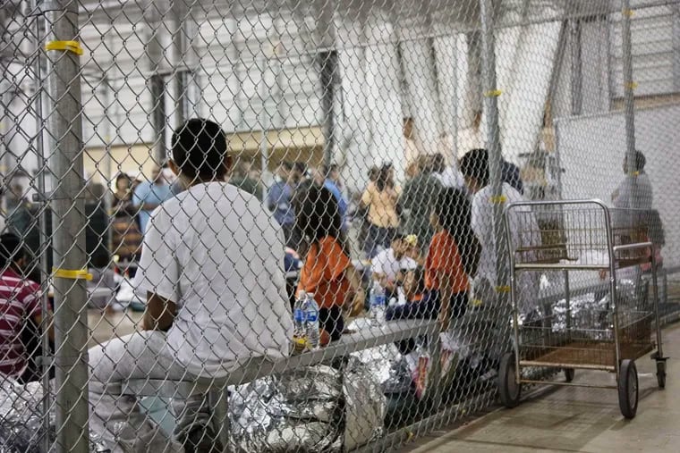 FILE - In this June 17, 2018, file photo, provided by U.S. Customs and Border Protection, people who have been taken into custody related to cases of illegal entry into the United States, sit in one of the cages at a facility in McAllen, Texas.  Immigrants accused the U.S. government in a lawsuit Wednesday of failing to promptly give them copies of their own immigration records, hampering their ability to fight deportation and apply for citizenship. (U.S. Customs and Border Protection's Rio Grande Valley Sector via AP, File)