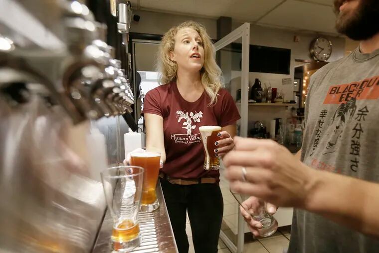 Human Village Brewing Co. co-owner Megan Myers serving customers during open mic night at the downtown Pitman, NJ brewpub. Myers says  new state regulations will  could force her to cancel the popular open mic events.