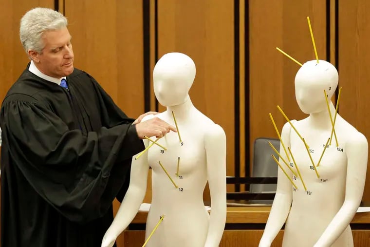 Judge John P. O'Donnell uses mannequins with gunshot wounds indicated to show that Officer Michael Brelo's shots alone didn't necessarily cause the deaths.