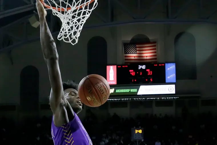 Roman Catholic sophomore Jalen Duren dunking in a big victory for the Cahillites over top-seeded Archbishop Wood in the semifinals of the Philadelphia Catholic League playoffs Feb. 19 in the Palestra.
