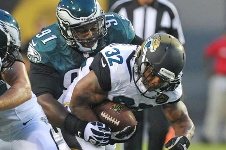 Jaguars running back Maurice Jones-Drew (32) is tackled by Philadelphia Eagles defensive tackle Fletcher Cox (91) during the first half of an NFL preseason football game, Saturday, Aug. 24, 2013, in Jacksonville, Fla. (Stephen Morton/AP)