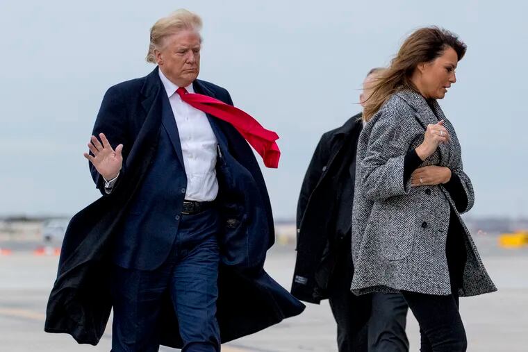 President Donald Trump and first lady Melania Trump walk to board Air Force One on a cold and windy afternoon at John F. Kennedy International Airport in New York, Tuesday, Nov. 12, 2019, to travel to Washington.