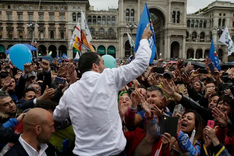 Supporters reach out to Lega leader Matteo Salvini during a rally in Milan, ahead of the European parliamentary elections.