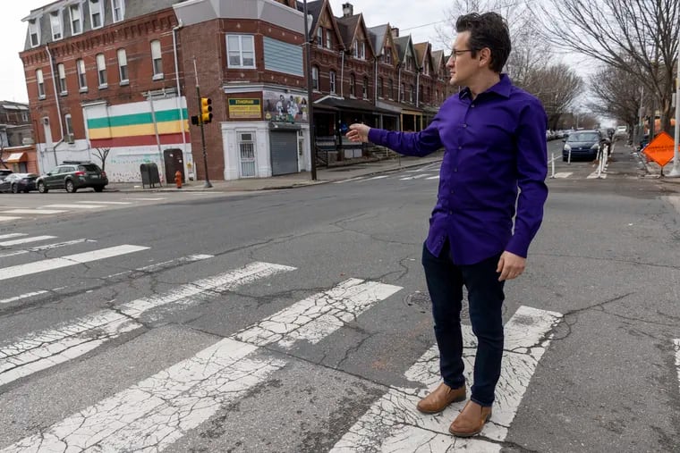 Ryan Spak, here at 44th and Chestnut Streets near the Ethiopian Community Association, works for the University City District to help residents, business owners, and community groups preserve and restore their properties in West Philadelphia.