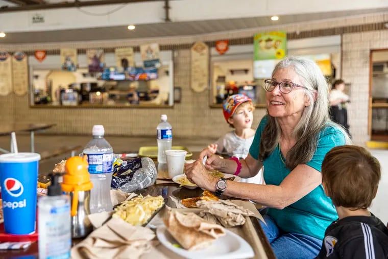 Patricia Buriak, of Bucks County, Pa., is eating lunch with her family at the at the International Food Court at Knoebels Amusement Resort in Elysburg, Pa.