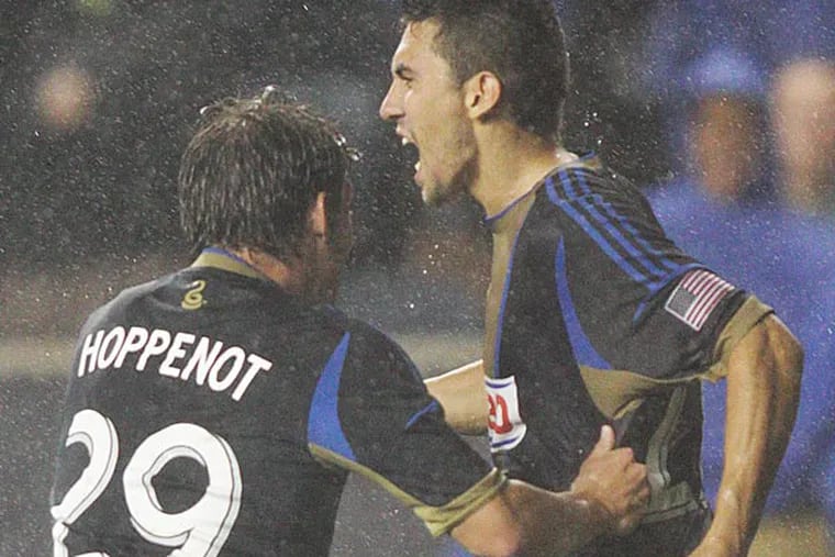 Union's Michael Farfan (21) celebrates with teammate Antoine Hoppenot (29) after scoring a direct free kick to go up one on Chivas USA during the second half at PPL Park. (Steven M. Falk/Staff Photographer )