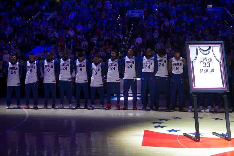 Sixers players stand during a tribute to Kobe Bryant before the team's game against the Golden State Warriors on Tuesday.
