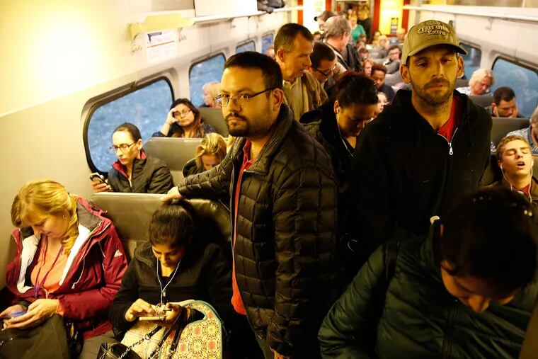 With city buses and subways shut down, passengers crowd a Trenton-bound Regional Rail train during the evening rush at the North Philadelphia station.