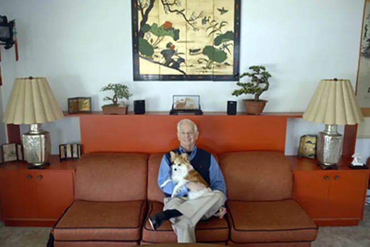 Jack Weinstein sits in his Asian inspired livingroom with his dog DJ. (Ron Tarver / Staff Photographer)