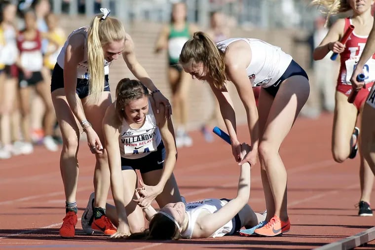 From left are Villanova's Rachel McArthur,Nicole Hutchinson and McKenna Keegan surround Siofra Cleirigh Buttner (on ground) after they won the distance medley Championship of America last year at Franklin Field.