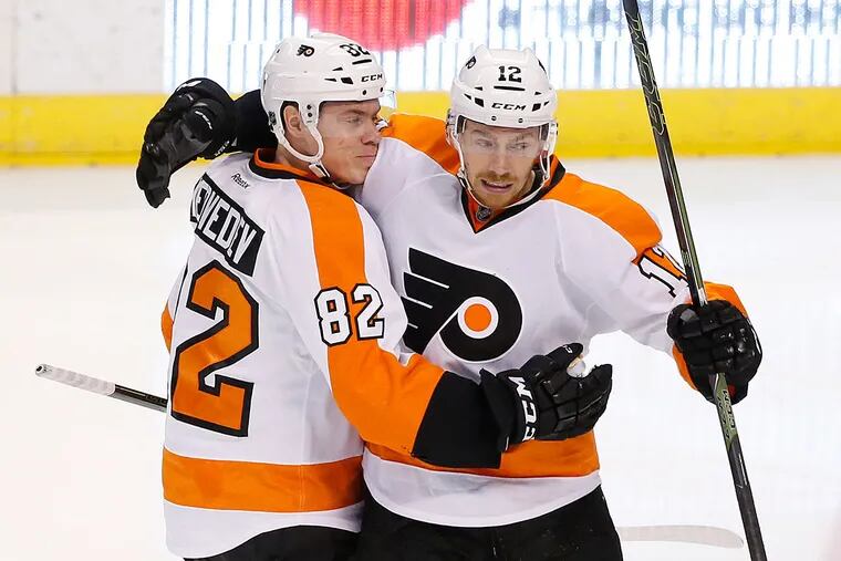 Philadelphia Flyers left wing Michael Raffl (12) celebrates a goal
with defenseman Evgeny Medvedev (82) during the third period of an NHL hockey game against the Florida Panthers, Saturday, March 12, 2016 in Sunrise, Fla.