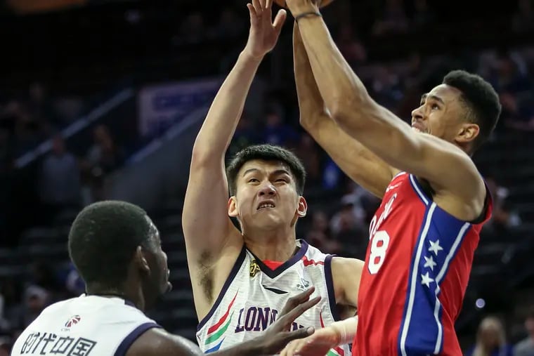 Sixers' Zhaire Smith shoots over Guangzhou Loong-Lions' Mingyang Sun (12) and Andrew Nicholson (44) during the 4th quarter of a pre-season game at the Wells Fargo Center in Philadelphia, Tuesday, October  8, 2019.   Sixers beat the Guangzhou Loong-Lions 144-86.
