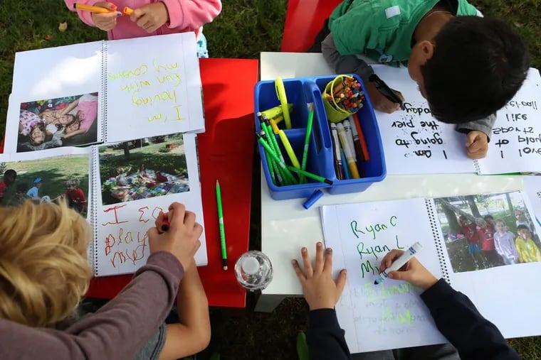 Students practice their writing during a camp for pre-K students in California.