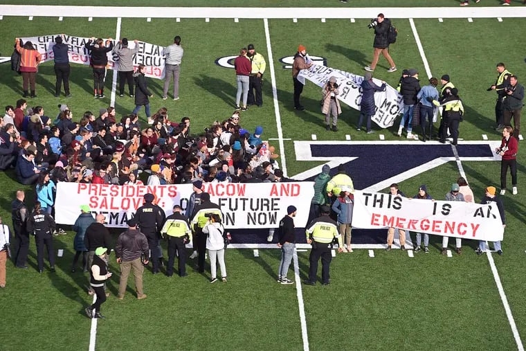 Demonstrators stage a climate change protest at the Yale Bowl delaying the start of the second half of an NCAA college football game between Harvard and Yale Saturday, Nov. 23, 2019, in in New Haven, Conn.