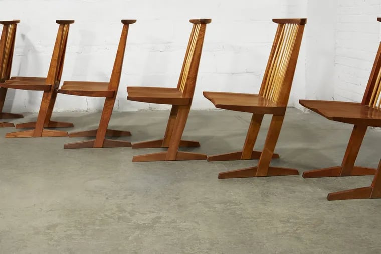 A set of six Conoid dining chairs, made of American black walnut and hickory by George Nakashima. The chairs, part of the Ottenberg collection, will be auctioned Monday at Freeman's auction house in Philadelphia.