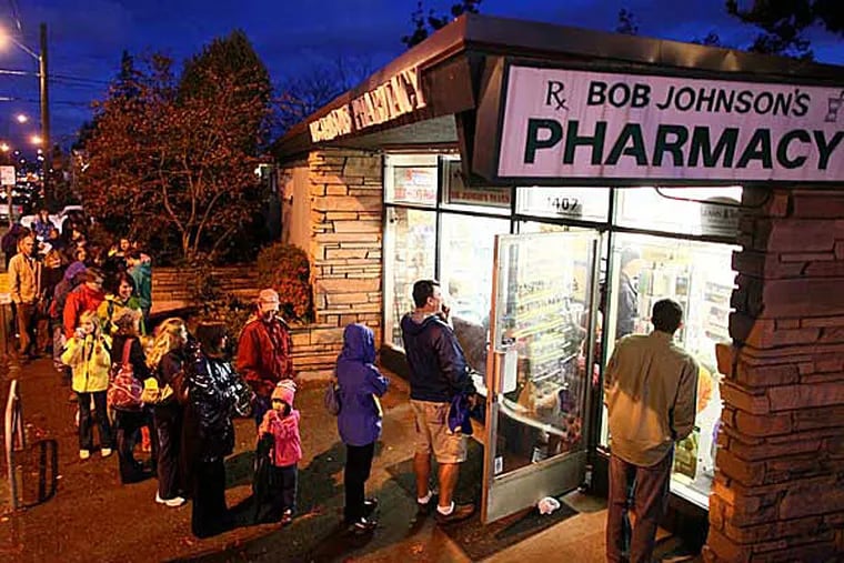 Customers wait in a line that stretches around the block for the H1N1 vaccine at a pharmacy in Seattle on Nov. 9. (JOSHUA TRUJILLO / Associated Press)