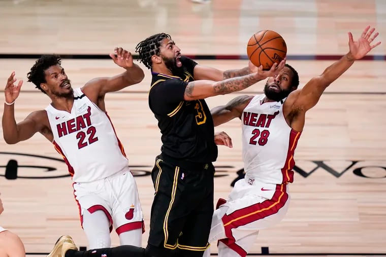 Lakers forward Anthony Davis shoots between Heat forward Jimmy Butler (left) and guard Andre Iguodala in the second half Friday.