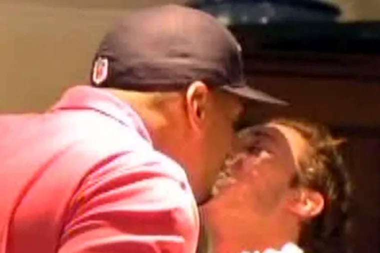 In this image taken from video, Missouri defensive end Michael Sam, left, gets a kiss at a draft party in San Diego, before he was selected in the seventh round, 249th overall, by the St. Louis Rams in the NFL draft Saturday, May 10, 2014. The Southeastern Conference defensive player of the year last season came out as gay in media interviews this year. (AP Photo/ESPN)