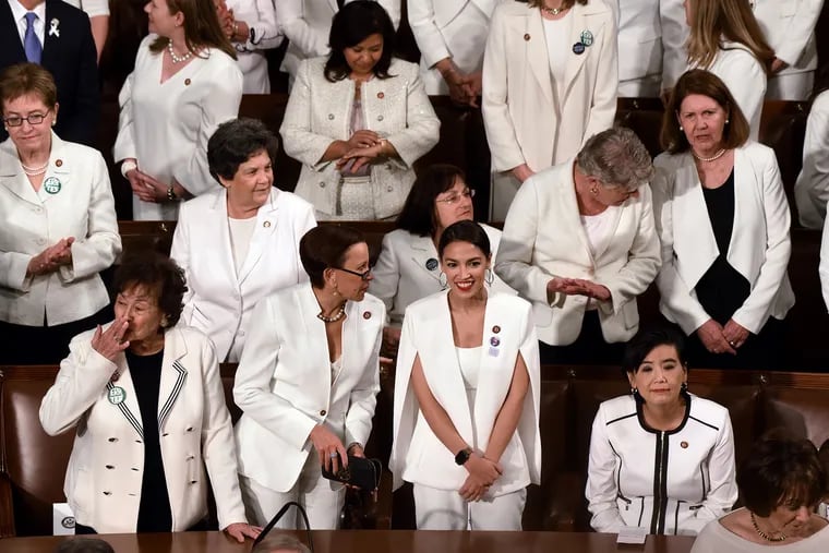 House Democratic women, including Rep. Alexandria Ocasio-Cortez (D-N.Y.), middle, are dressed in white for President Trump's State of the Union address to a joint session of Congress on Capitol Hill in Washington, D.C., on Tuesday, Feb. 5, 2019. (Olivier Douliery/Abaca Press/TNS)