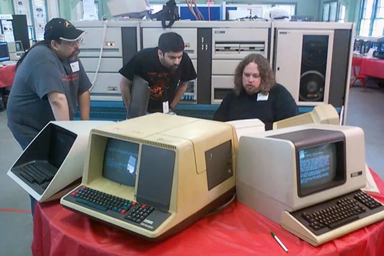 (Left to right) Ethan Dicks, Sridhar Ayengar and Dave McGuire, members of Mid-Atlantic Retro Computing Hobbyists, use terminals to connect to a Digital Equipment Corp. "PDP-11/70" from 1974. (Evan Koblentz courtesy photo)