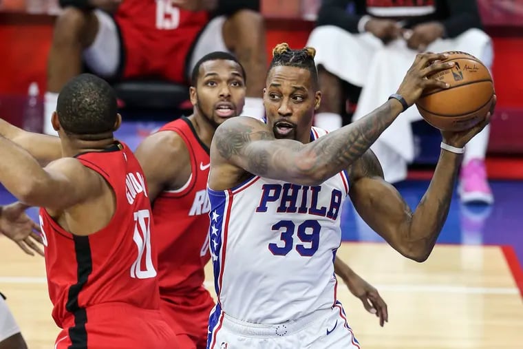 The Sixers' Dwight Howard looks to pass around the Rockets' Eric Gordon (left) and Sterling Brown during the third quarter.