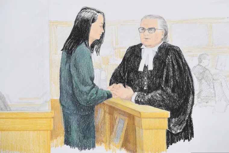 In this courtroom sketch, Meng Wanzhou, left, the chief financial officer of Huawei Technologies, speaks to her lawyer David Martin during a bail hearing at British Columbia Supreme Court in Vancouver, British Columbia, Monday, Dec. 10, 2018. (Jane Wolsak/The Canadian Press via AP)
