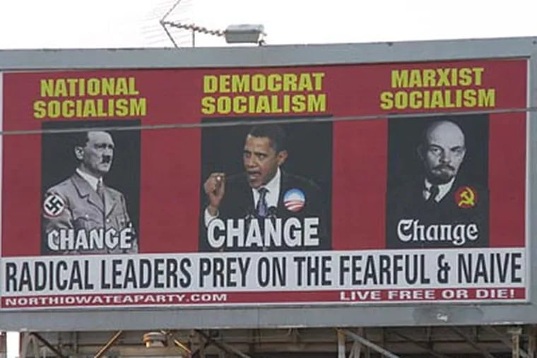 A billboard ordered and paid for by the North Iowa Tea Party shows President Barack Obama, Adolf Hitler, left and Vladimir Lenin, on South Federal Avenue in Mason City, Iowa, July 12, 2010. (AP Photo/Globe Gazette, Deb Nicklay)