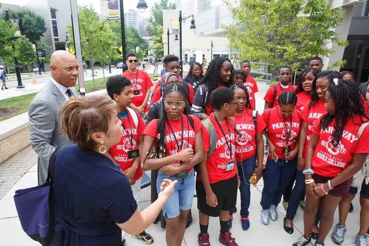 Principal Anh Nguyen, of Parkway Center City Middle College, and William R. Hite Jr., superintendent of Philadelphia schools, (back left) with students on their first day of class at Community College of Philadelphia in 2017.