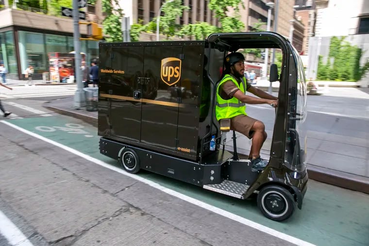 UPS worker Dyghton Anderson peddles an eQuad electric bike in a bicycle lane while delivering packages in New York on Tuesday.