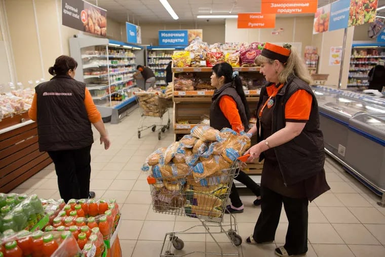 Workers at a Dixie supermarket in Moscow restock shelves with bread on Tuesday. Suppliers suffering from ruble depreciation this quarter are urging retailers to increase prices. Russian government bonds rose and stocks erased an earlier loss after the nation's Finance Ministry canceled its fifth bond auction in six weeks. Russia pulled the sale due to &quot;current market conditions,&quot; the ministry said in a website statement.