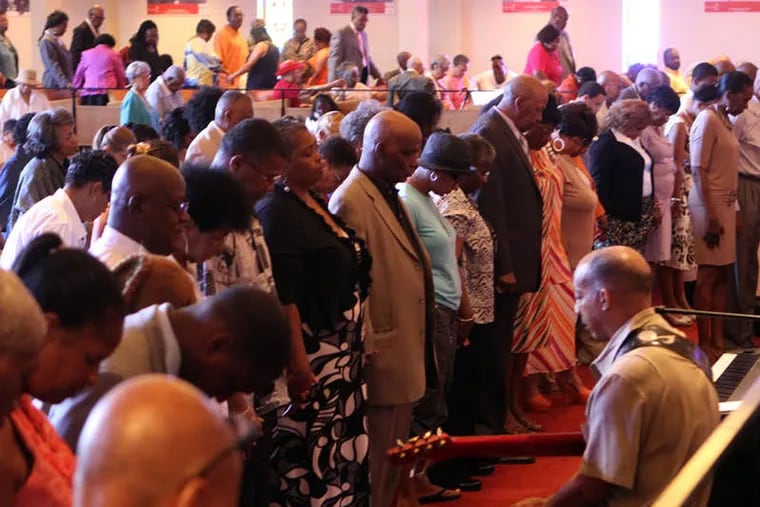 Congregants pray for Trayvon Martin at Philadelphia’s Bright Hope Baptist Church during a service in June 2013.