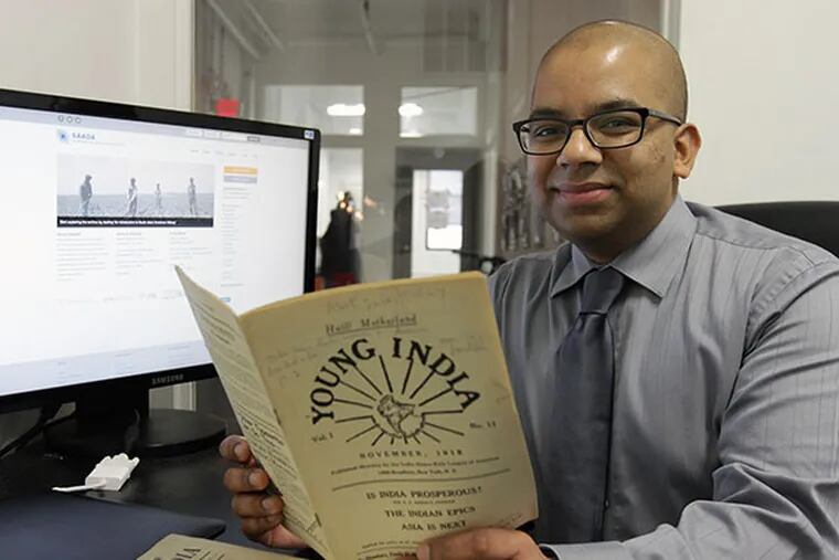 Samip Mallick, who runs the South Asian American Digital Archive, holds a publication from 1918 that he digitized for the archive in Philadelphia on February 4, 2014. ( DAVID MAIALETTI / Staff Photographer )