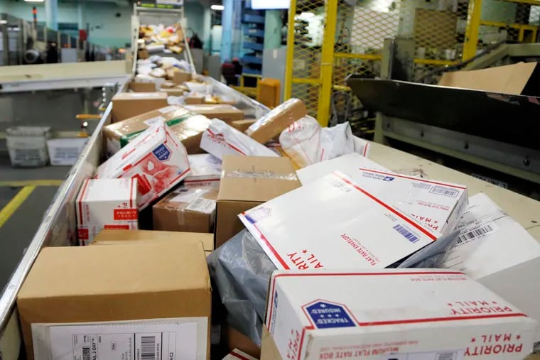 Packages travel on a conveyor belt for sorting at the main post office in Omaha, Neb.