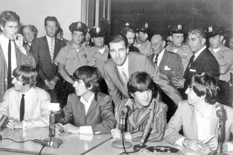 Hy Lit (center, leaning) with the Beatles before their 1964 concert at Convention Hall.