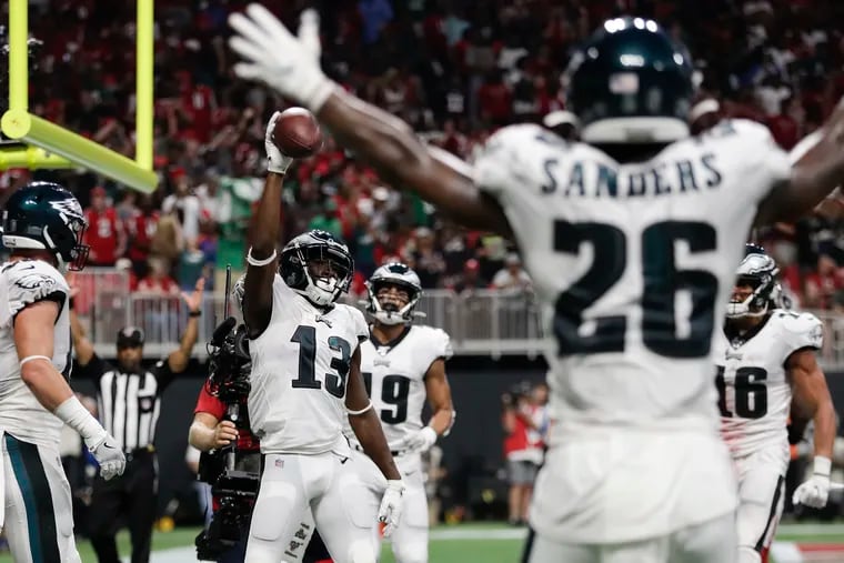 Eagles wide receiver Nelson Agholor raises the football after catching a third-quarter touchdown against the Atlanta Falcons on Sunday, September 15, 2019 in Atlanta.