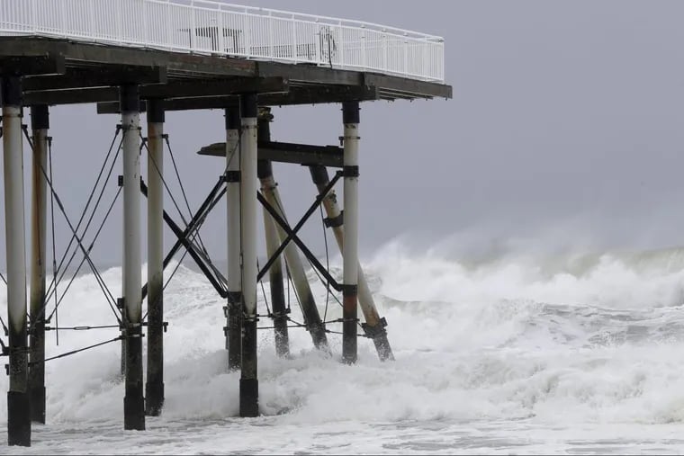 Waves knocked down piles on a fishing pier in Belmar, N.J., on Tuesday.