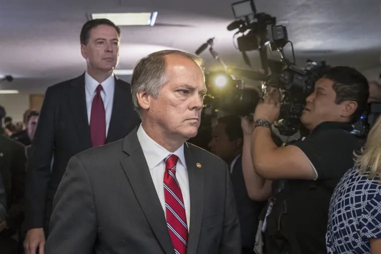 In this June 8, 2017 photo, James Wolfe, center, former director of security with the Senate Intelligence Committee, escorts former FBI director James Comey to a secure room to continue his testimony on the 2016 election and his firing by President Donald Trump. Federal prosecutors are accusing Wolfe with lying to the FBI about contact he had with reporters who covered the committee.
