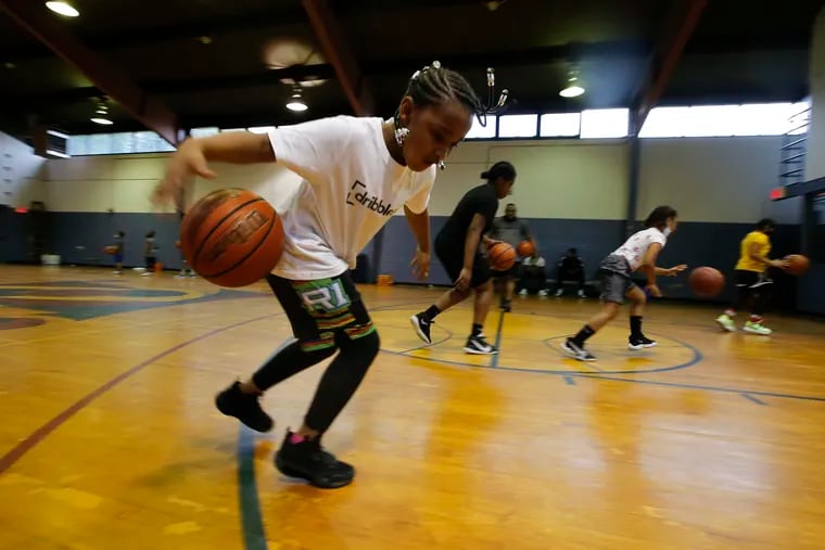 Happy Hollow Recreation Center Youth Basketball participant Amari Price, 7, works on her dribbling skills in Germantown basketball gym.