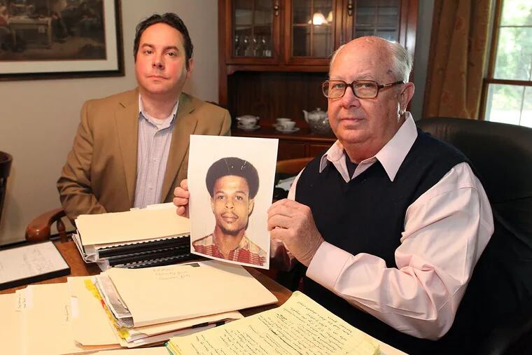 Alan Maimon (left) and Jim McCloskey of Centurion Ministries, a Princeton-based organization that has helped free 54 inmates from prison in three decades, with a photograph of Larry Walker, who has been in prison for 33 years for a murder he says he did not commit. The men presented the case for Walker’s innocence to the Conviction Review Unit in the Philadelphia District Attorney’s Office, but were unsuccessful.