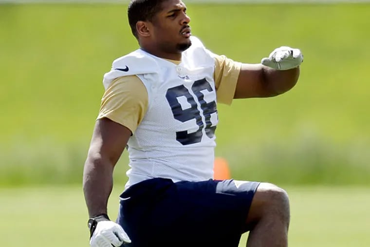 St. Louis Rams rookie defensive end Michael Sam stretches during the team's NFL football rookie camp Friday, May 16, 2014, in St. Louis. (Jeff Roberson/AP)