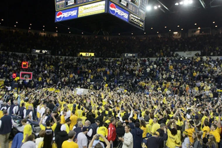 Michigan fans pour onto the court following the Wolverines&#0039; 81-73 upset win over No. 4 Duke in Ann Arbor, Mich.