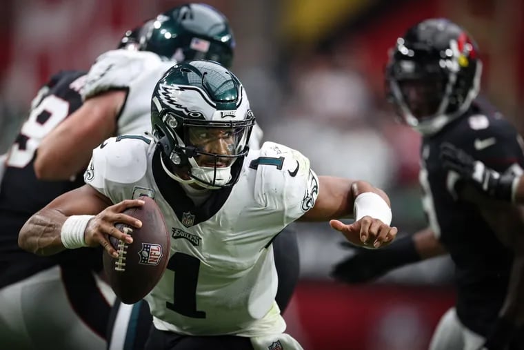 Philadelphia Eagles quarterback Jalen Hurts tries to scramble away from the pressure as they play the Cardinals at State Farm Stadium in Glendale, Ariz. on Sunday, Oct. 9, 2022.