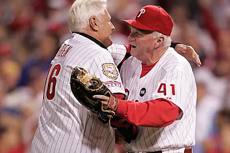 Dallas Green receives a hug from Charlie Manuel after throwing the ceremonial pitch before Game 5 of the NLCS. (David Swanson / Staff Photographer)