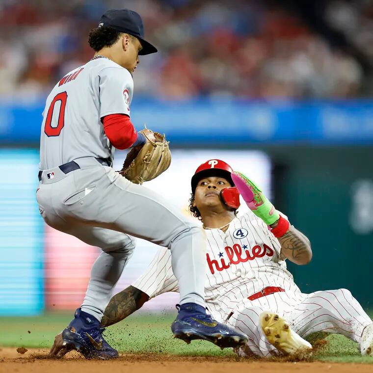 Phillies Cristian Pache falls down after getting tagged out by Cardinals shortstop Masyn Winn in the eighth inning.
