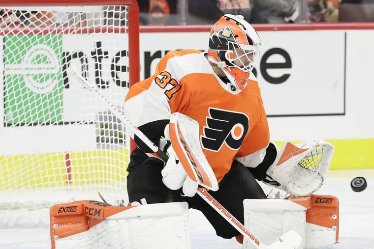 Flyers goaltender Brian Elliott stops the puck against the Colorado Avalanche in a recent game. He was injured Sunday and had to leave practice.
