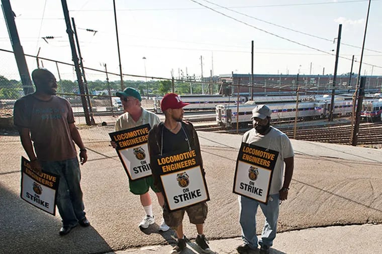SEPTA workers picket outside the SEPTA Roberts Avenue Yard in June. (Ron Tarver / Staff Photographer)