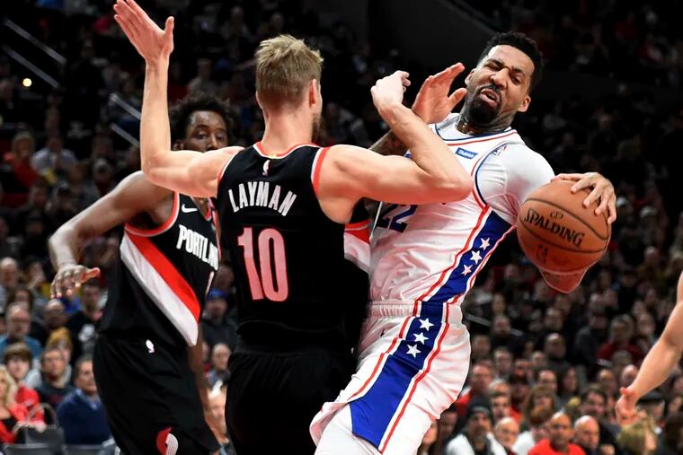 Wilson Chandler (right) is fouled by Portland's Jake Layman during the first half of the Sixers' loss on Sunday.